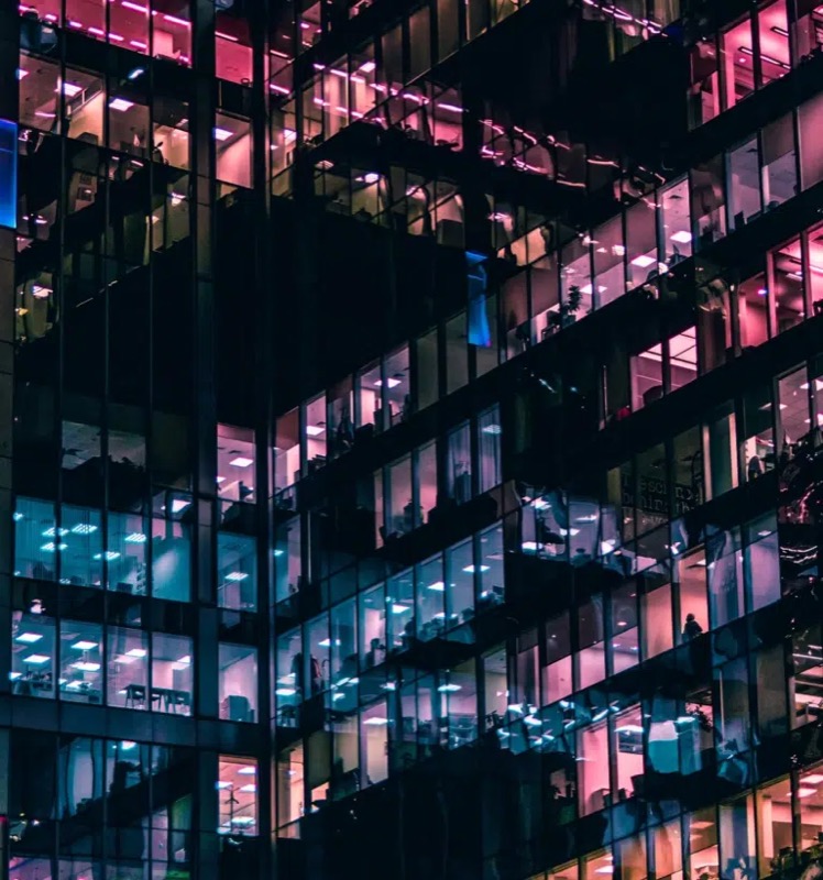 A lit office tower at dusk